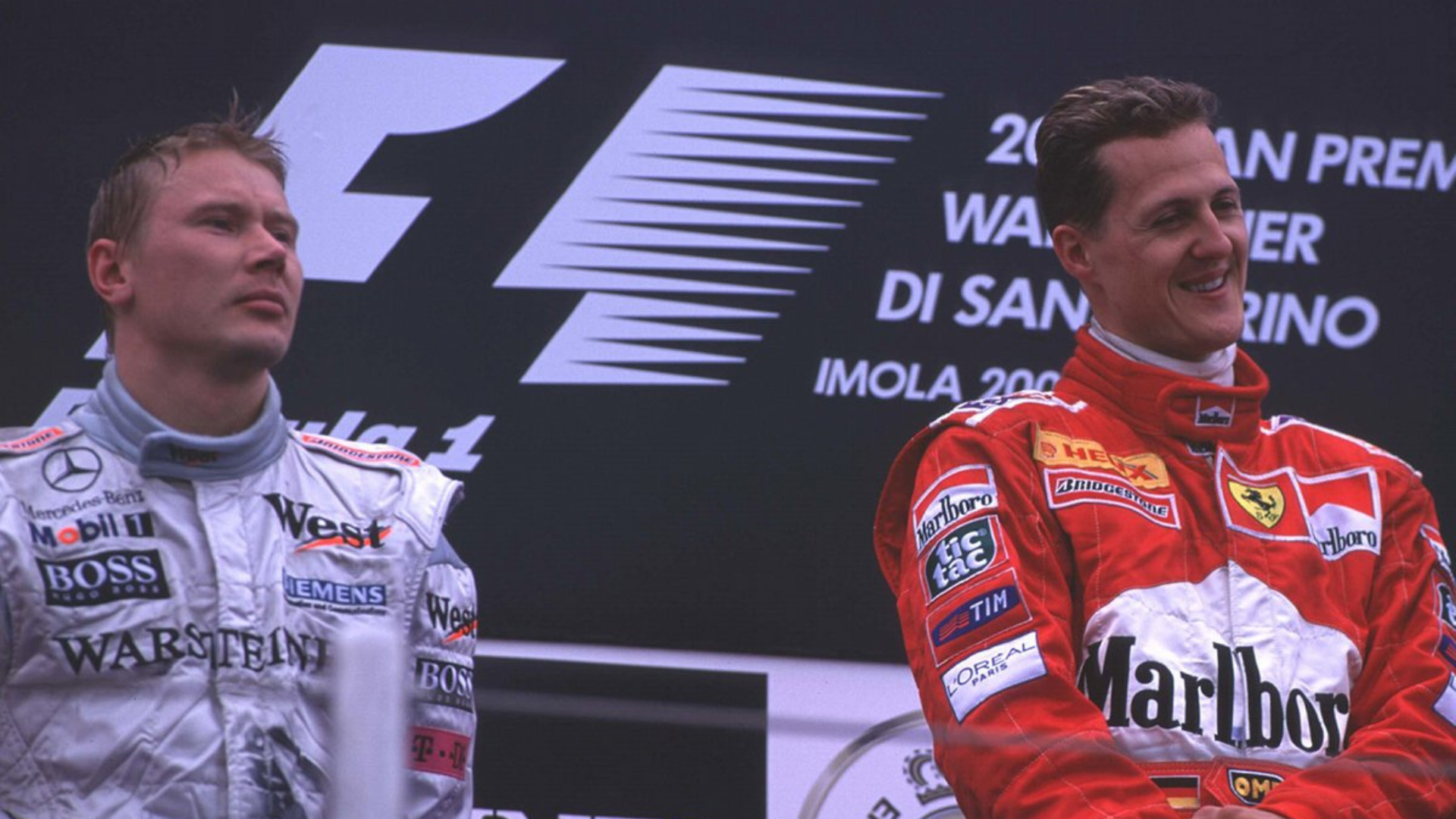 F1 drivers, Michael Schumacher and Mika Häkkinen celebrating their podium results.