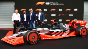 Audi Formula One car with Audi F1 executives and senior management standing behind during a presentation.