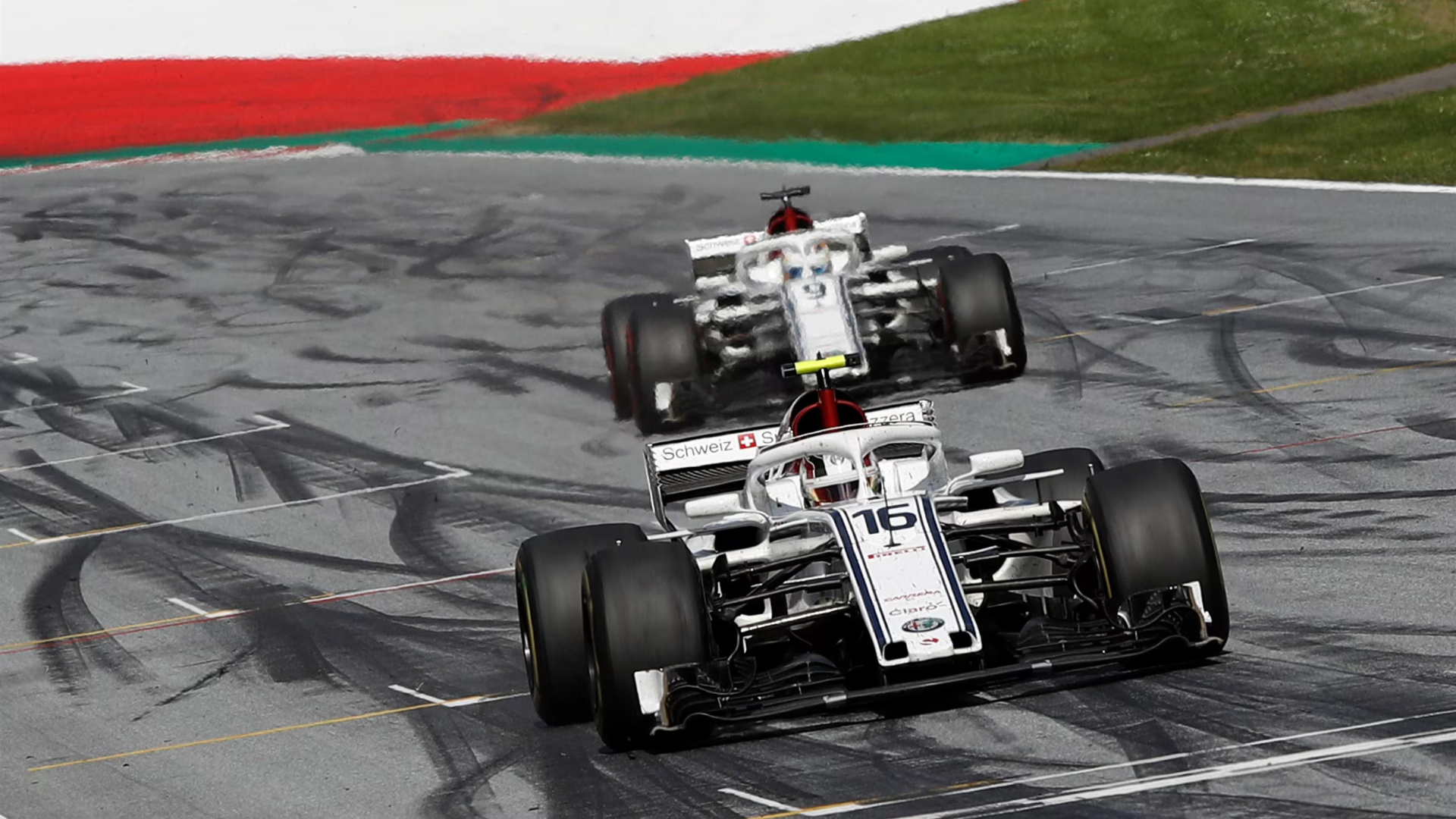 Two Sauber F1 Team C37 cars running together on track during the 2018 Formula 1 season