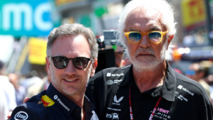 Christian Horner standing with Flavio Briatore in the Formula 1 paddock during a Grand Prix weekend.