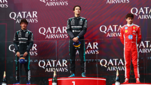 George Russell celebrates victory on the podium at the 2026 Australian Grand Prix with Kimi Antonelli and Charles Leclerc at Albert Park