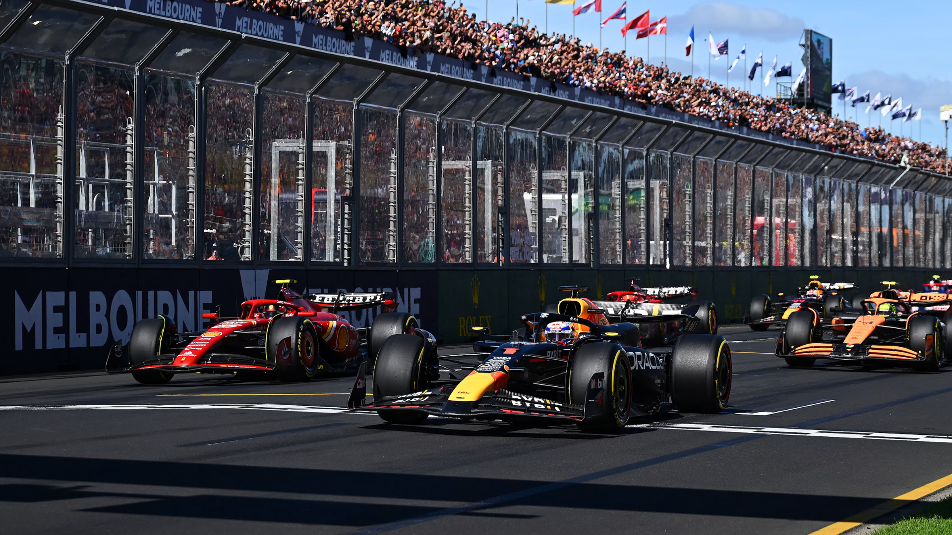 Formula 1 cars racing at Albert Park during the Australian Grand Prix in Melbourne with Ferrari, Red Bull and McLaren battling on track